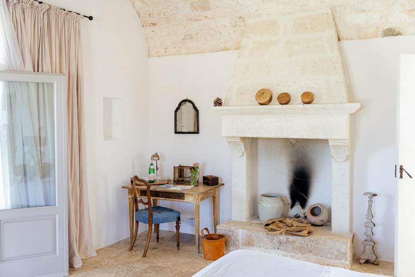 Masseria Petrarolo bedroom with cozy bed and firespace