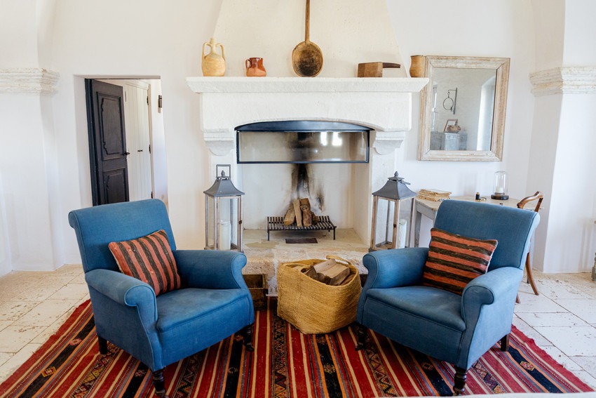 Masseria Petrarolo living area with armchairs and fireplace