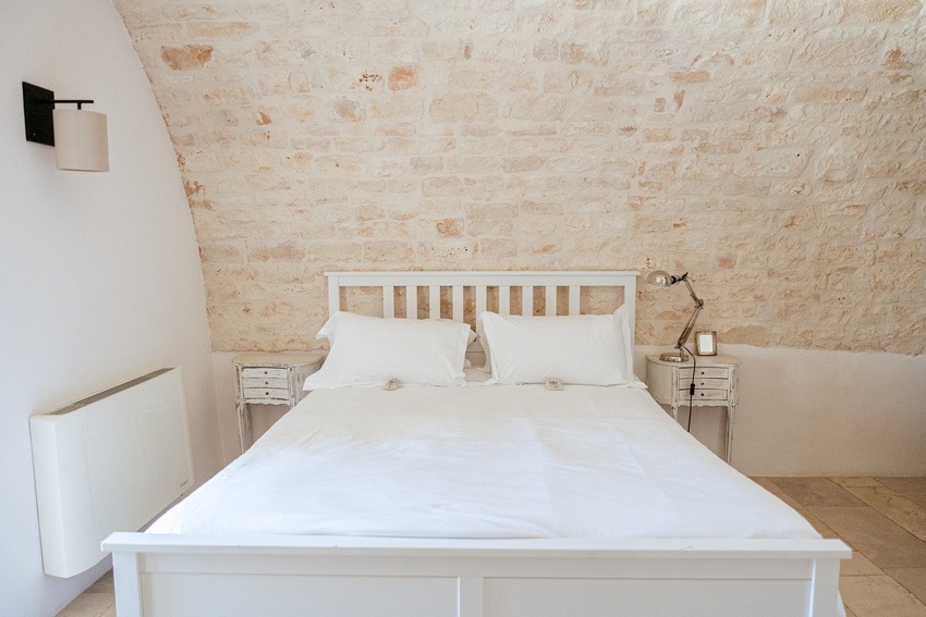 Masseria Petrarolo bedroom with stone architecture and modern comfort