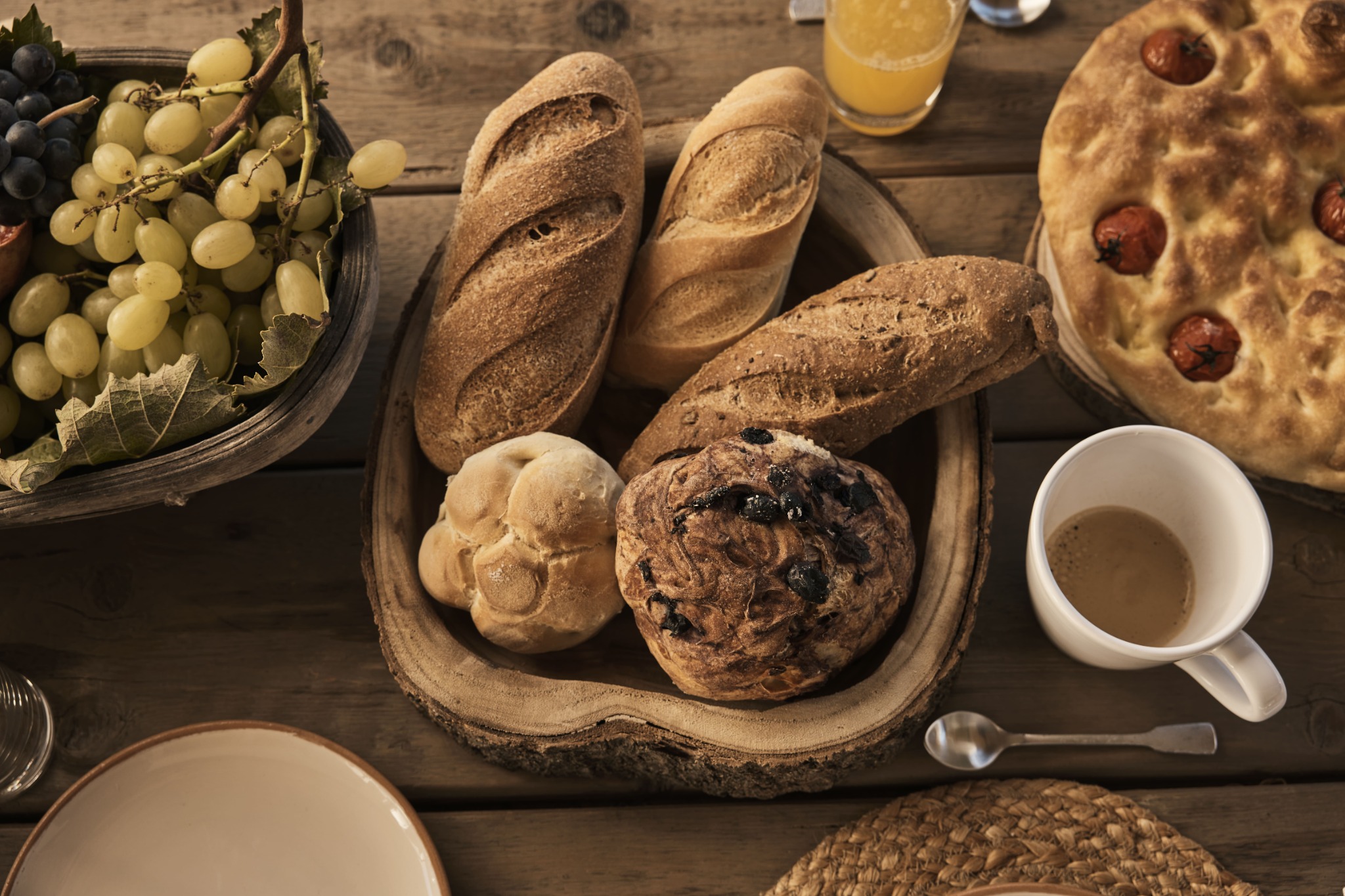 Freshly baked bread and focaccia with grapes and coffee