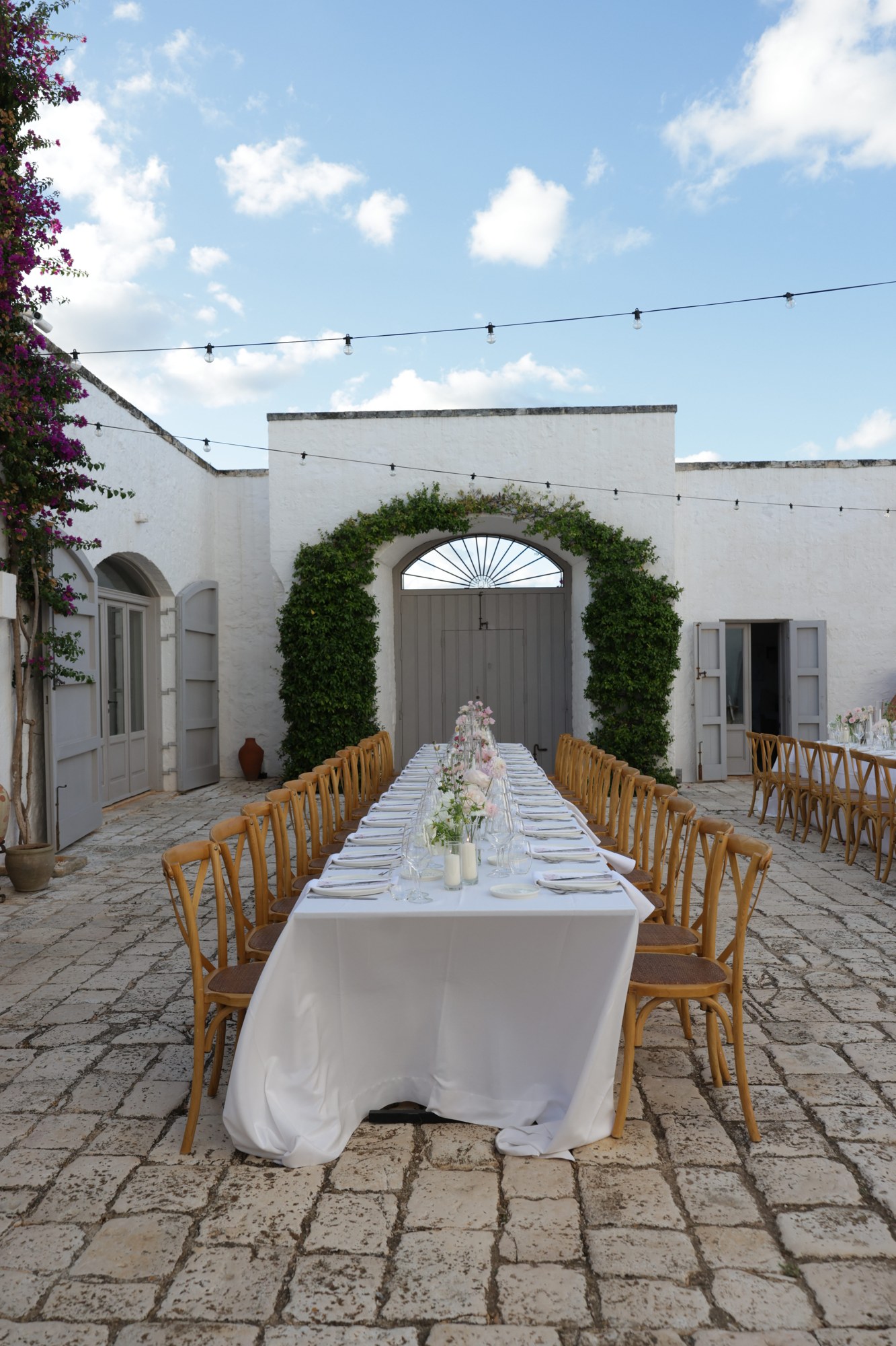 A long table set for a celebration in the Masseria courtyard