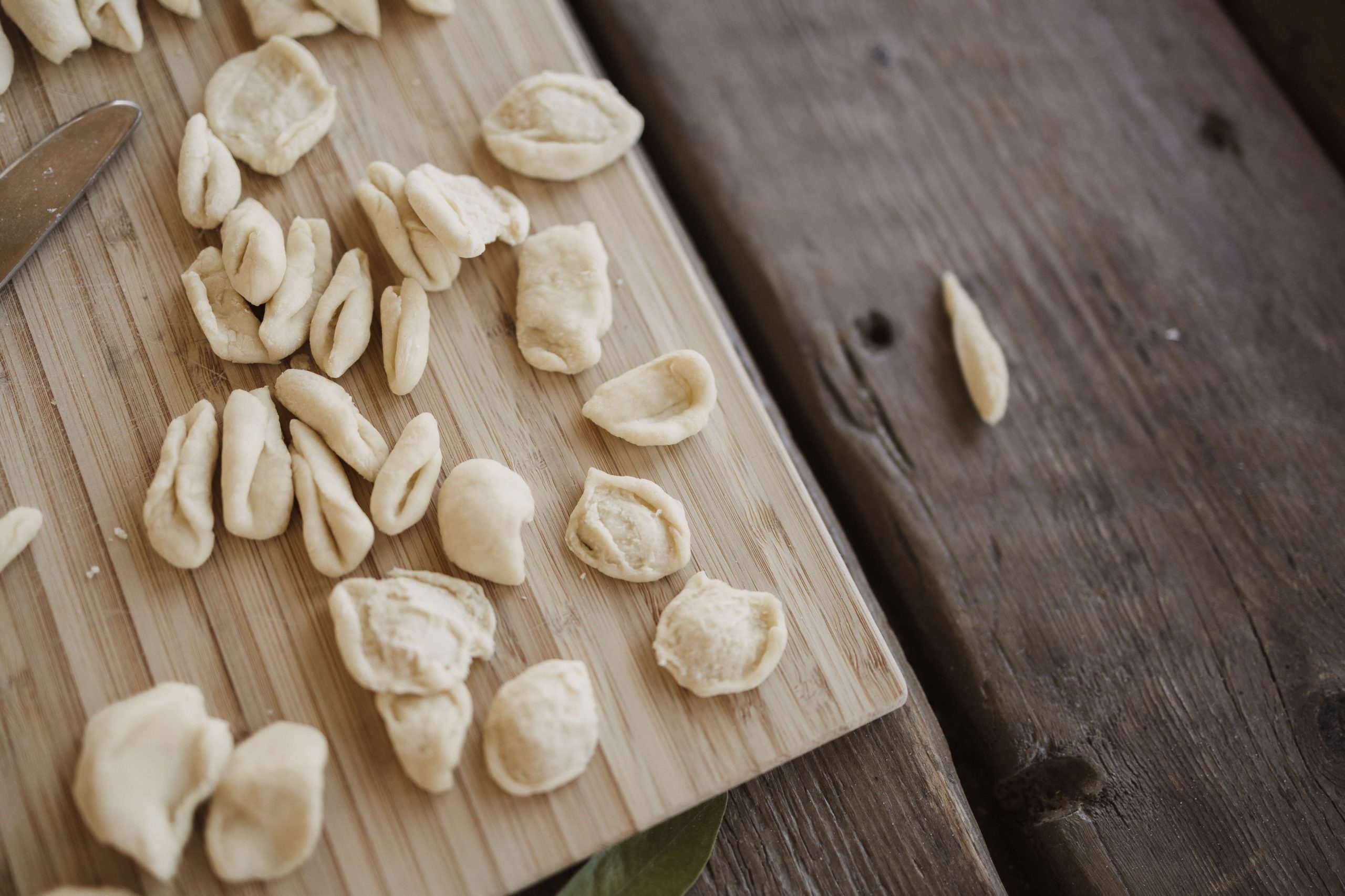 Handmade orecchiette pasta on a wooden board