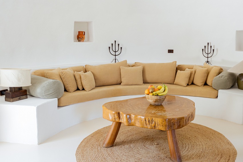 The curved sofa and welcoming sitting room at Trullo Petrarolo